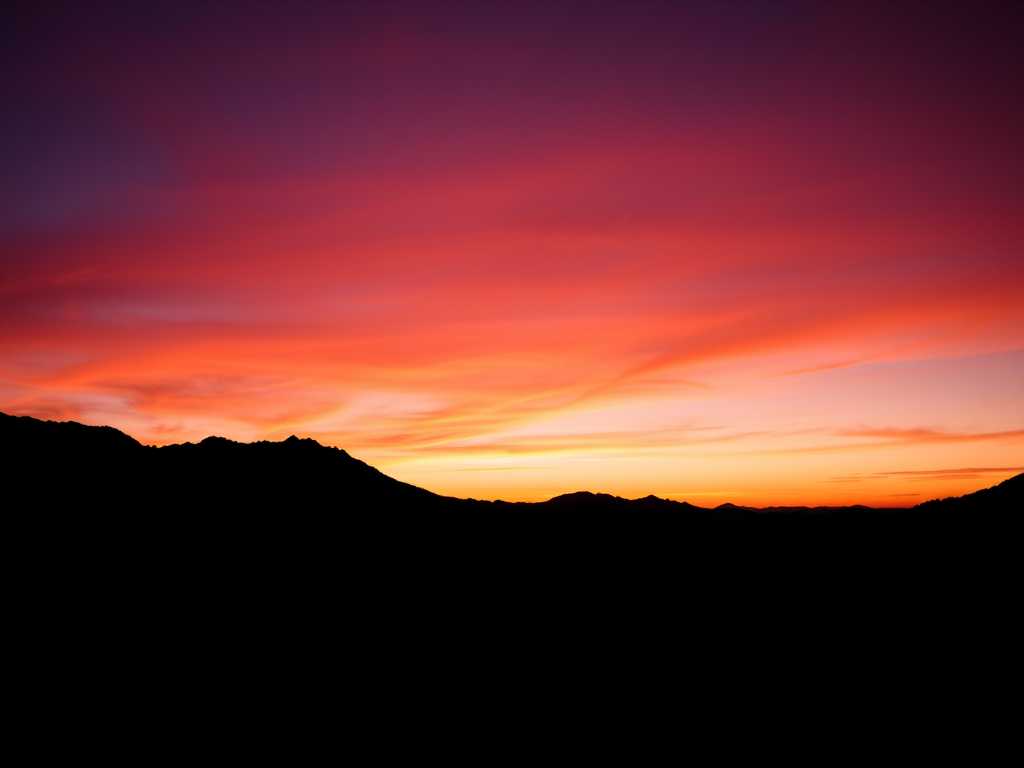 Generate a high-resolution image of a stylized black silhouette of a mountain landscape at sunset, with vibrant orange and purple hues in the sky, taken with a Canon EOS R5 camera, at ISO 100, f/11 aperture, 24mm focal length, in landscape orientation, with a wide-angle lens to capture the full expanse of the scene.
