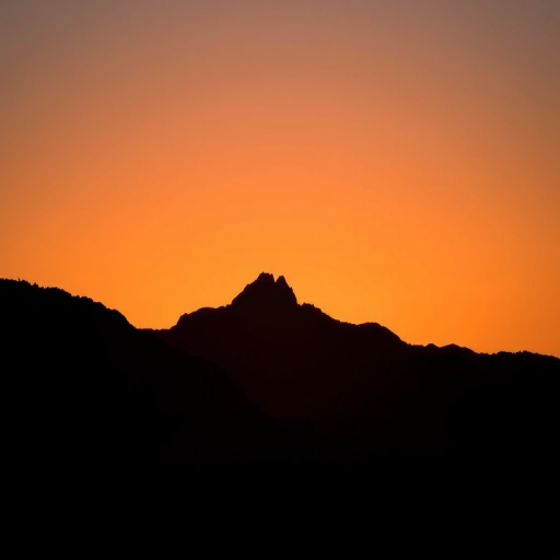 Create a high-resolution image of a stylized black silhouette of a mountain range against a sunset gradient background, captured with a Canon EOS R5, 50mm lens, f/1.8 aperture, ISO 100, and soft focus to enhance depth.