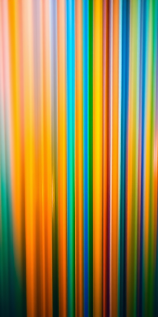 Generate a vibrant abstract background featuring vertical lines in shades of blue, orange, yellow, and green with a 3D perspective, captured using a Canon EOS R5 with a 50mm f/1.2 lens, aperture set to f/8, ISO 100, and a low angle view to enhance depth.