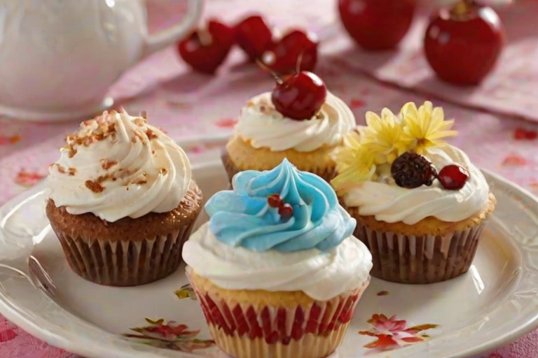 Generate an image of a plate of delicious cupcakes with fluffy frosting on top. Some cupcakes should be partially cut to reveal a cherry filling inside. The cupcakes should be decorated with chocolate shavings and placed on a decorative stand. Include a floral tablecloth in the background for a cozy, inviting atmosphere.