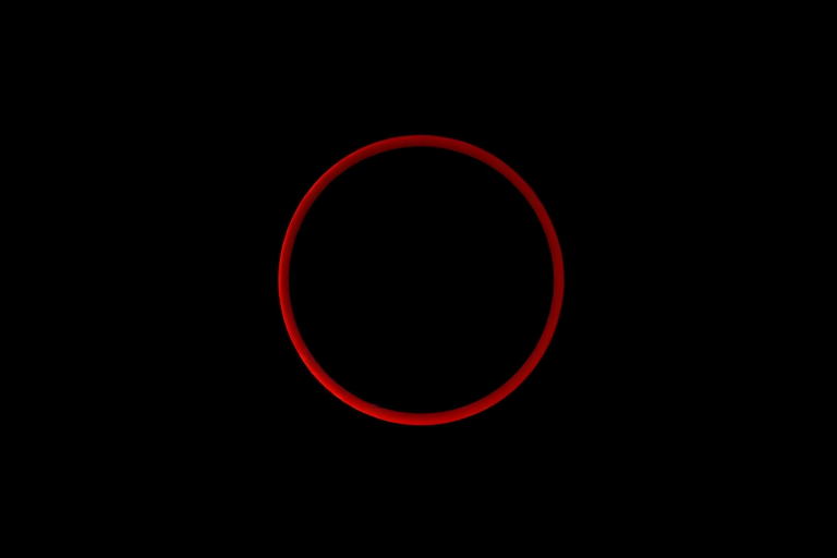 Generate an image of a red keyhole shape on a solid black background, using a DSLR camera, 50mm lens, aperture f/2.8, ISO 100, and a shallow depth of field for enhanced clarity and contrast.