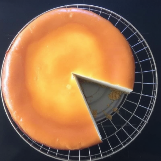 A freshly baked cheesecake with a golden brown top, resting on a round wire rack, with a slice removed revealing its creamy interior and crumbly crust, set against a dark surface.
