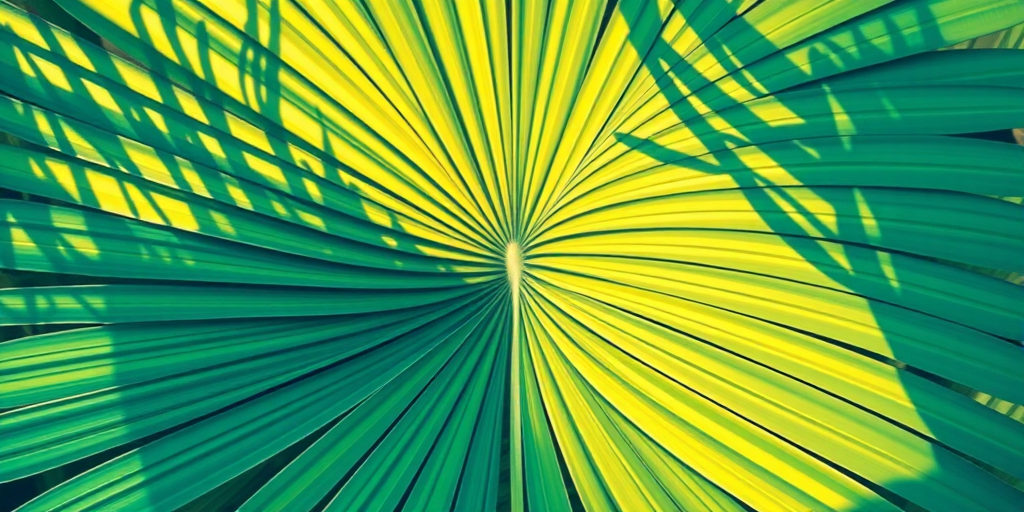 Capture a highly detailed and vibrant illustration of a tropical palm leaf, centered in the frame, using a DSLR camera with a 50mm lens, aperture f/2.8, ISO 100, and natural lighting for enhanced color depth and sharpness.