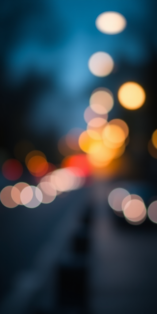 Create a highly detailed, out-of-focus bokeh background with colorful circular lights, using a Canon EOS R5 camera, 50mm f/1.2 lens, aperture set to f/1.2, ISO 100, shutter speed 1/200 sec, shot at dusk for rich colors and depth.