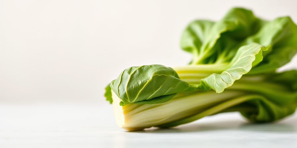 Take a high-resolution image of a fresh bok choy against a clean, neutral background using a DSLR camera with a 50mm lens, aperture set to f/2.8 for a blurred background effect, ISO 100, and natural light for enhanced color vibrancy.