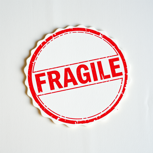 Create a high-resolution image of a stamp that reads "FRAGILE" in bold red letters surrounded by a circular border, using a DSLR camera with a 50mm lens, f/2.8 aperture, and ISO 100, shot from a top-down view with soft natural light to enhance texture and clarity.
