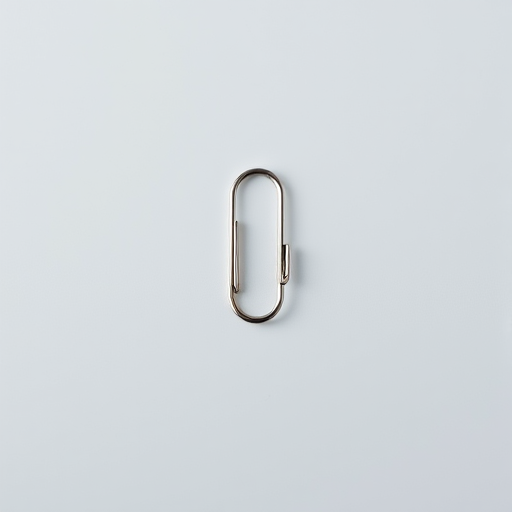 Capture a high-resolution image of a paperclip in a minimalistic setting, using a DSLR camera with a 50mm lens, aperture set to f/2.8 for shallow depth of field, ISO 100 for clarity, natural lighting to enhance details, shot at eye level for perspective.
