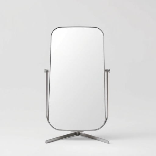 Create a high-resolution image of a standing mirror with a minimalist design, shot from a frontal view at a low angle, using a DSLR camera with a 50mm lens, aperture set to f/2.8, ISO 100, and a shutter speed of 1/200s, ensuring even lighting and a clean background.