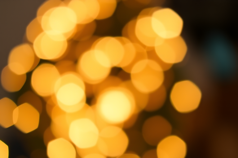bokeh background with soft sparkling lights, aperture f/2.8, ISO 100, shutter speed 1/60s, shot with a DSLR camera from a close-up perspective, soft focus effect to enhance light reflections