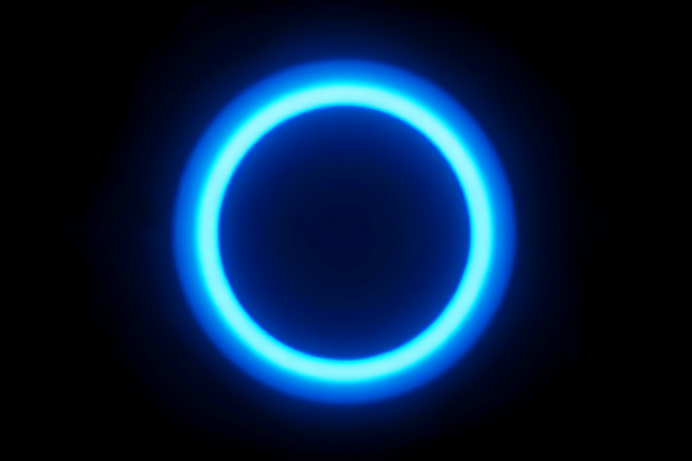 highly detailed digital art of a glowing blue circular light on a black background, emphasize luminosity and depth, shot with a Canon EOS R5, aperture f/2.8, ISO 100, 50mm lens, soft focus, long exposure effect for enhanced glow and smooth gradients