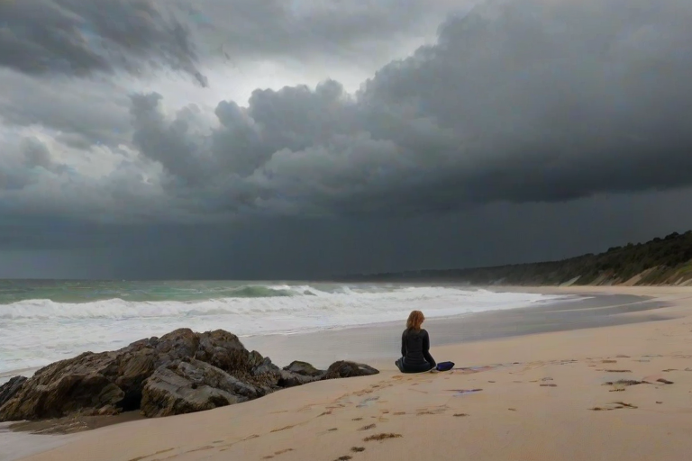 Secluded beach on a cloudy day, waves crashing against the rocks, a woman sits on the sand, her knees pulled up to her chest as she watches the storm clouds gather on the horizon.