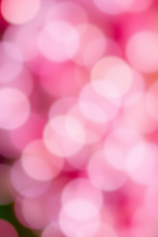 Create an abstract image of colorful blurred circles in shades of pink, purple, and cream with a bokeh effect, captured with a Canon EOS R5, using a 50mm lens at f/1.8, ISO 100, shutter speed 1/200s, in soft focus to enhance depth and richness.