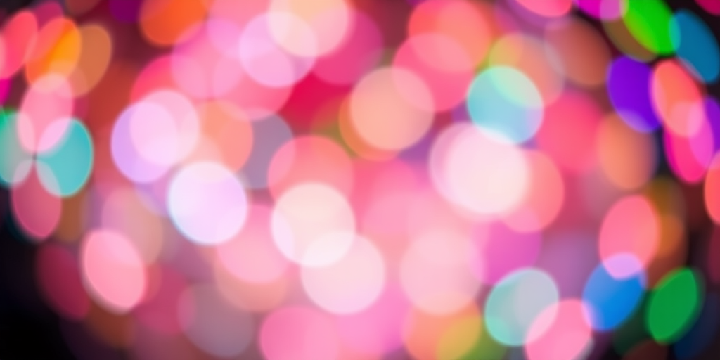 create an abstract image of colorful bokeh lights with a blurred background using a DSLR camera at f/2.8 aperture, ISO 100, 50mm lens, and a shallow depth of field, capturing vibrant hues and circular light shapes in a softly blended composition