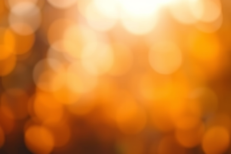 Create a high-resolution image of a soft-focus bokeh background with warm tones of orange and yellow, using a Canon EOS R5 camera, 50mm lens, f/1.8 aperture, ISO 100, and a shallow depth of field for a dreamy effect.