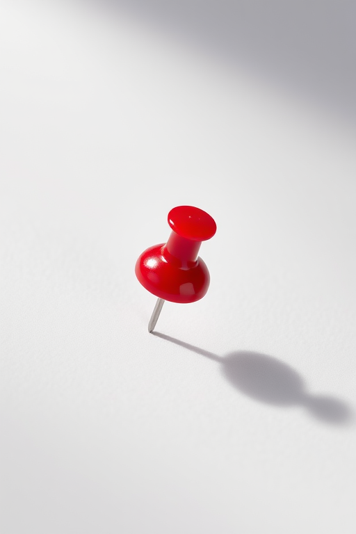 Create a high-resolution image of a glossy red pushpin on a white background with soft shadows, using a DSLR camera set to aperture f/2.8, shutter speed 1/100 sec, ISO 100, shot from a macro view to enhance details and textures.