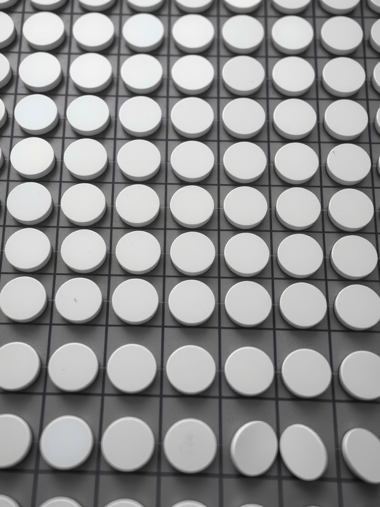 Create a high-resolution image of a repeating pattern of alternating black and white circles on a grid, shot with a Canon EOS 5D Mark IV at 50mm, f/8, ISO 200, in sharp focus with even lighting and a clean minimalist style.