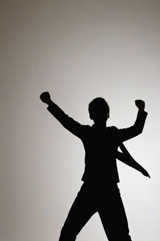 Create a silhouette of a person standing with arms raised in a celebratory pose, against a simple background.