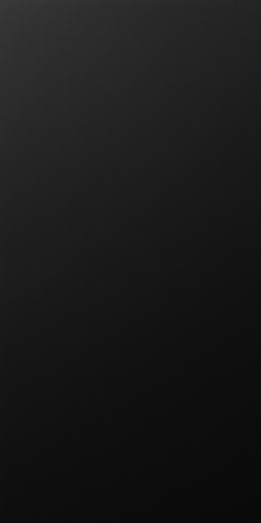 Generate a high-resolution image of a blank black surface with a smooth texture, using a DSLR camera with a 50mm lens, f/1.8 aperture, ISO 100, and a low angle shot to enhance contrast and details.
