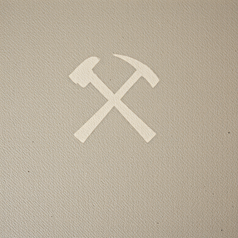 Create a high-resolution image of a crossed hammer and pickaxe logo on a textured background, using a Canon EOS R5 camera with a 50mm f/1.8 lens, aperture set to f/4, ISO 100, natural lighting, and a shallow depth of field for a professional look.