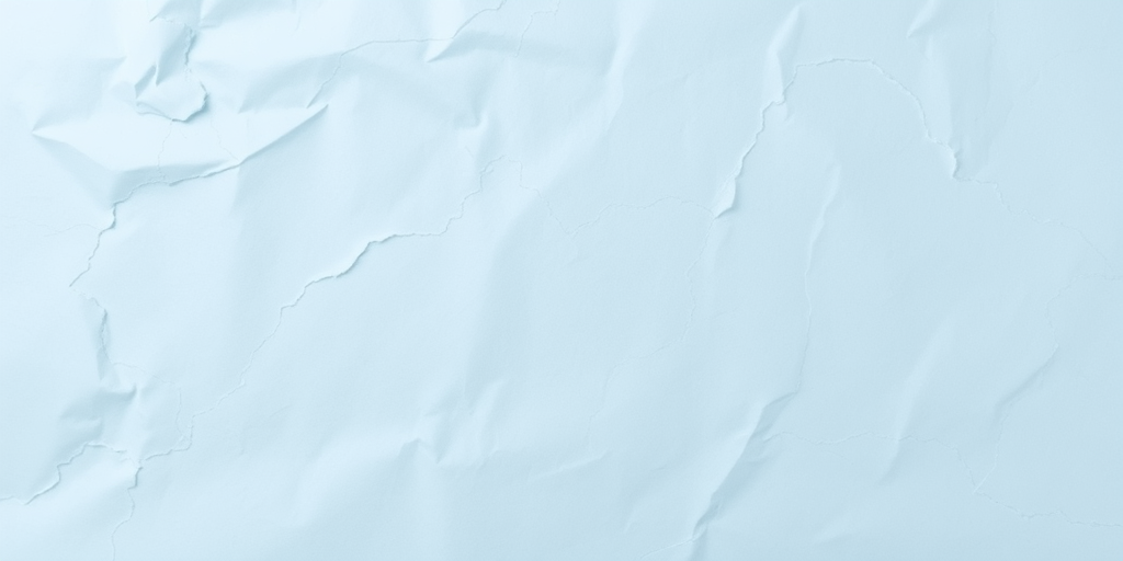 Generate an image of a wrinkled light blue paper background, soft focus, 50mm lens, f/2.8 aperture, ISO 100, top-down view, DSLR camera, natural lighting.
