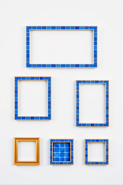 Generate an image of five picture frames with a blue tiled border, including one large rectangle, one medium rectangle, and three smaller squares, all set against a light gray background, captured with a DSLR camera at f/7.1 aperture, ISO 100, 50mm lens, soft focus view to enhance sharpness and clarity.