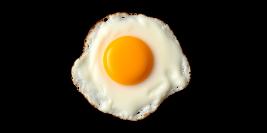 Create a high-resolution image of a fried egg on a black background using a DSLR camera with a 50mm lens, aperture set to f/2.8, ISO 100, and a soft, diffused lighting setup for enhanced clarity and color vibrancy.
