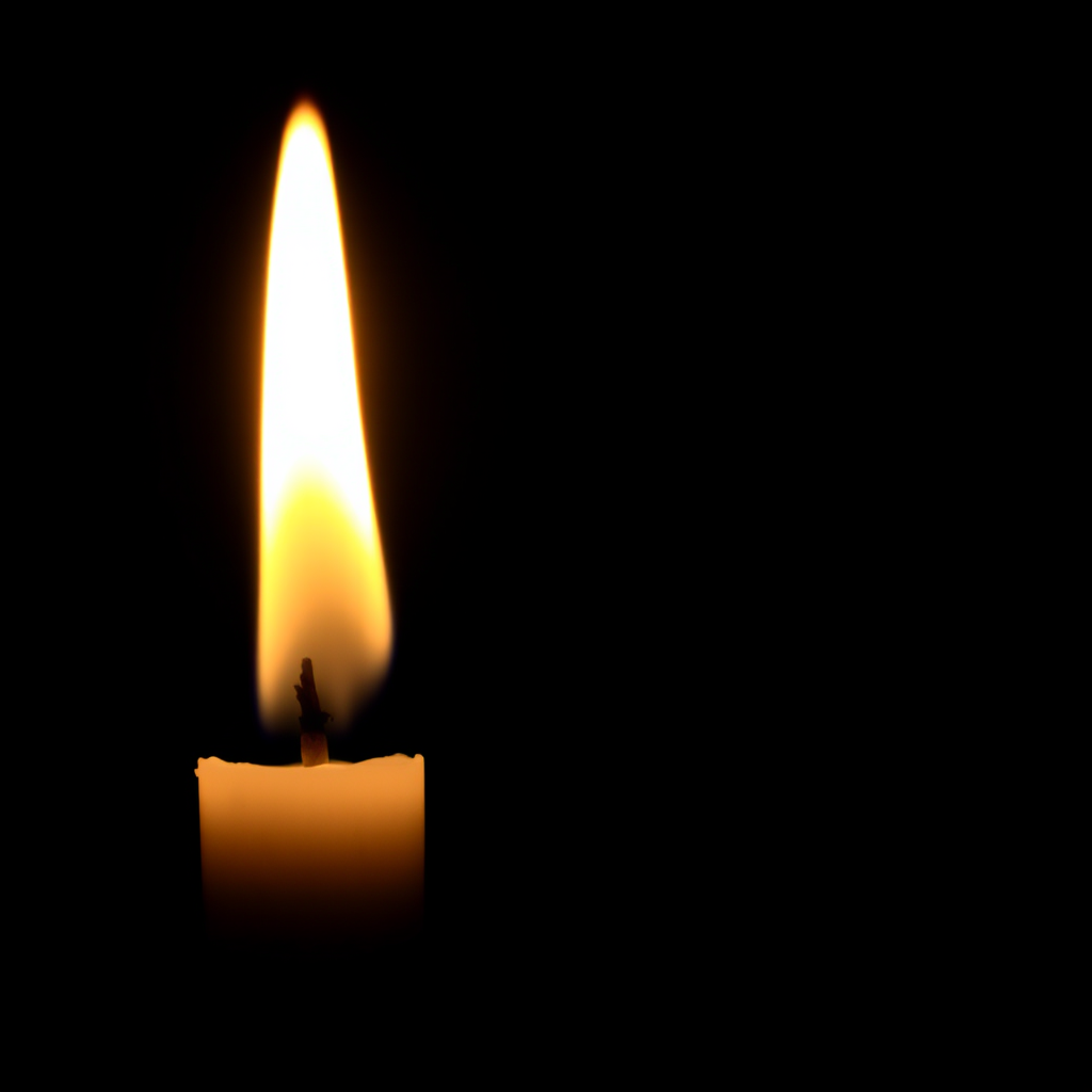 Create an image of a lit candle with a bright, flickering flame against a dark background, using a DSLR camera with a 50mm lens, aperture set to f/1.8 for a shallow depth of field, ISO 100 for minimal noise, and a soft focus effect to enhance the warm glow and surrounding bokeh.