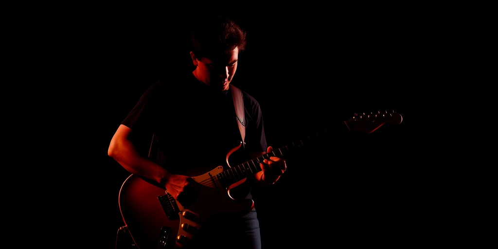 Create a high-contrast silhouette of a guitarist playing an electric guitar against a black background, using a DSLR camera with a 50mm lens, aperture set to f/1.8, ISO 100, and a shutter speed of 1/1000 seconds to capture sharp details and vibrant colors.