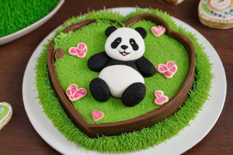 Create an image of a heart-shaped chocolate cake surrounded by decorative cookie sticks. The cake features a cute panda figurine sitting on top, along with green grass-like decorations. The background should be simple to highlight the cake's details.