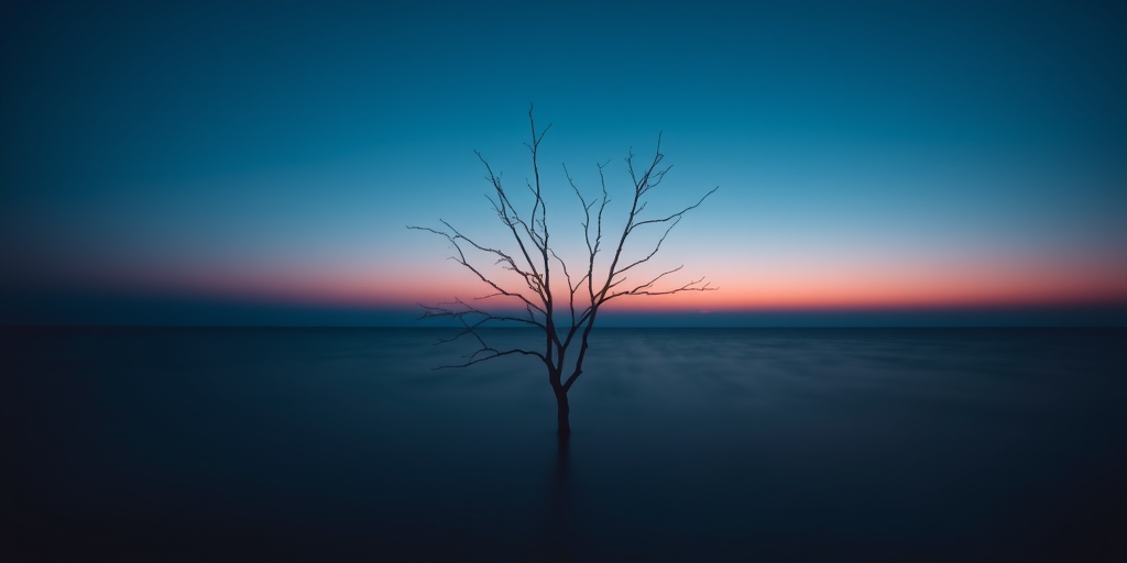 A solitary barren tree standing in calm, dark blue waters at twilight, captured with a full-frame DSLR, ISO 200, f/8, 1/60 sec, using a wide-angle lens and a low-angle shot to highlight the tree's silhouette against the serene horizon.