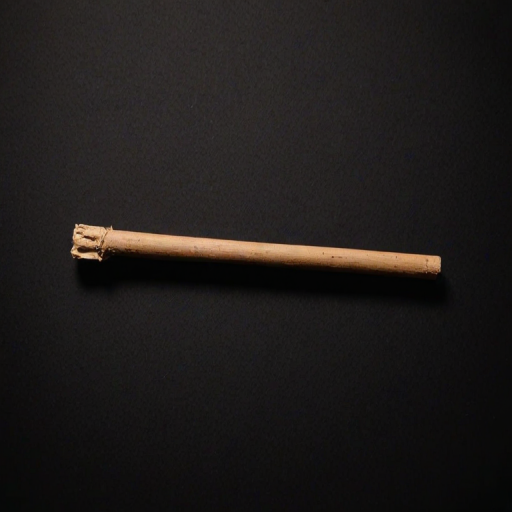 a simple brown wooden stick lying horizontally on a black background