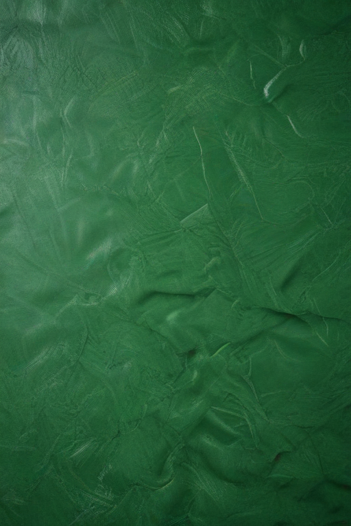 Textured Green Surface with Rich Depths and Subtle Variations in Tone