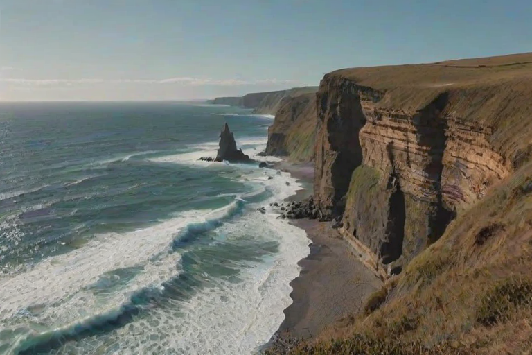 Dramatic coastal cliff, with waves crashing below, a solitary figure standing at the edge, taking in the breathtaking view of the ocean and horizon.