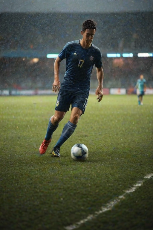 Blurry action shot of a soccer player dribbling the ball down a rain-soaked field, soft light from the stadium illuminating the scene, with water spraying up from their cleats and distant teammates watching intently.