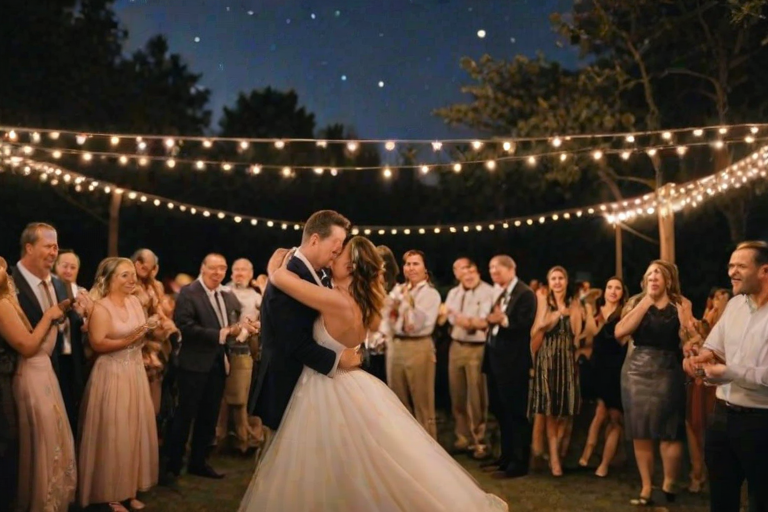 Charming outdoor wedding venue, decorated with flowers and twinkling lights, guests mingling, and a couple sharing a dance under the stars.