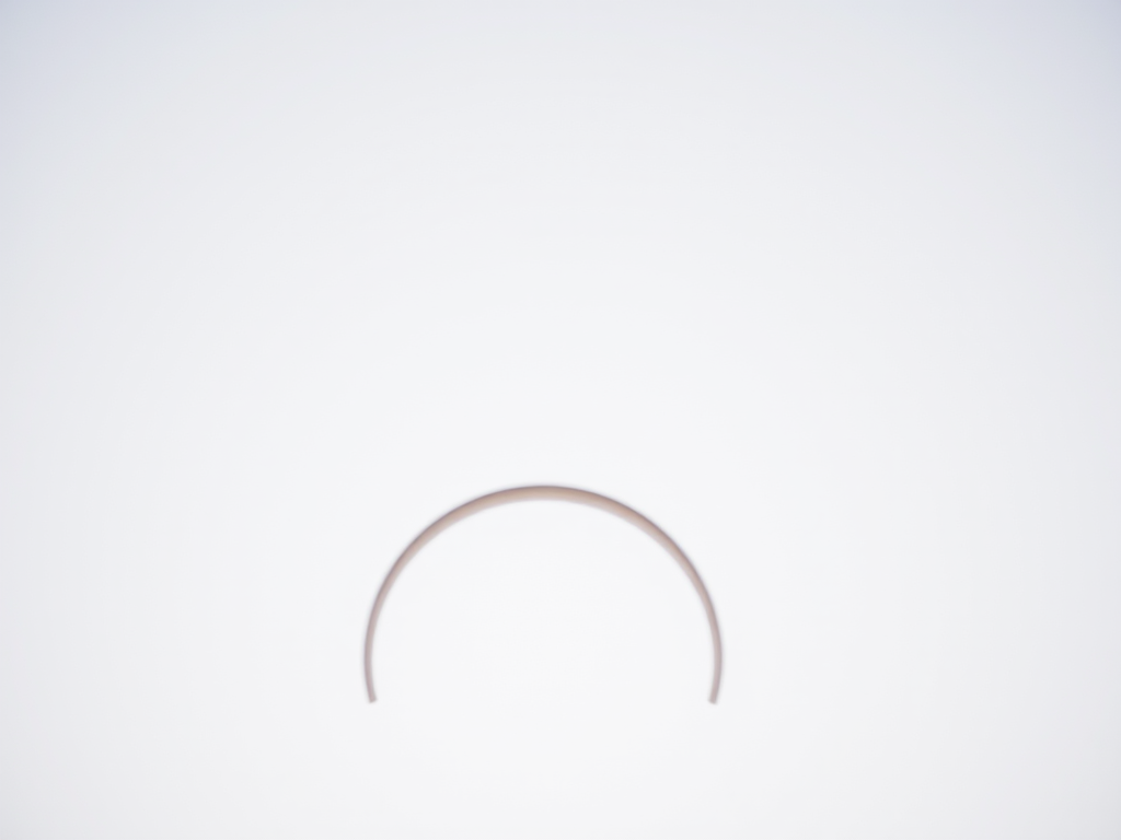 Create a high-resolution image of interconnected crescent shapes, using a Canon EOS R5, aperture f/8, shutter speed 1/250s, ISO 100, with a shallow depth of field, from a slightly elevated perspective, with a clean and minimalist background for enhanced contrast.