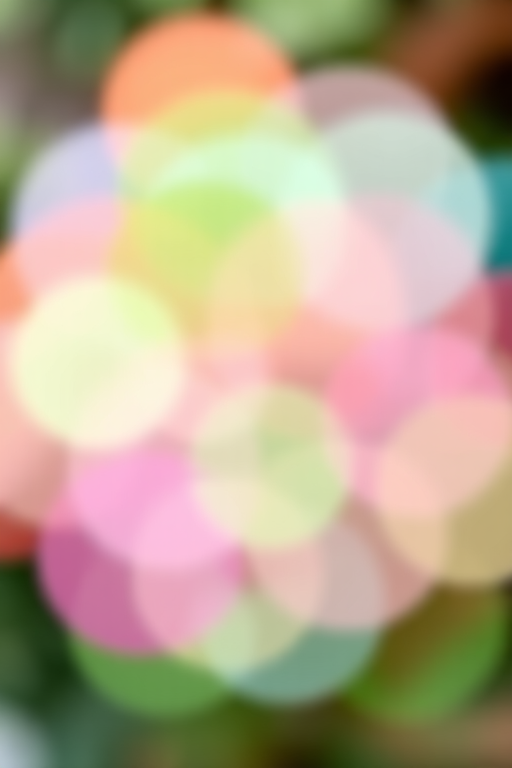 Create an abstract image of overlapping colorful circles in shades of green, pink, and blue with a soft, blurred effect, using a DSLR camera with a 50mm lens, f/1.8 aperture, ISO 200, and a shallow depth of field, capturing the scene from a top-down perspective to enhance bokeh quality.