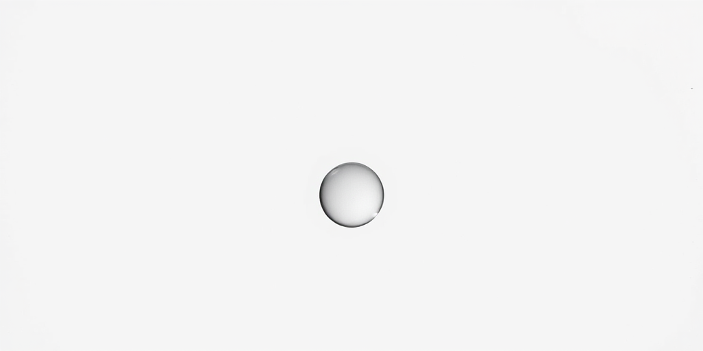 Create a minimalistic image of a water droplet with a smooth gradient, set against a soft white background, using a DSLR camera with a 50mm lens at f/2.8 aperture, ISO 100, and a shallow depth of field, capturing it from a slightly elevated angle to enhance the visual appeal.