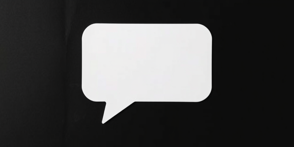 generate a clean, minimalist white speech bubble on a black background, using a DSLR camera with a 50mm lens, aperture set to f/2.8, ISO 100, shutter speed 1/200 sec, shot from a straight-on view to enhance contrast and detail.