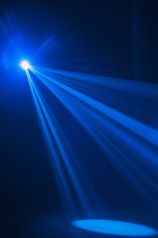 Create an abstract image of a bright blue light source radiating beams in a dark space with a high dynamic range, using a Canon EOS R5, 24mm lens, aperture f/8, ISO 200, and 1/100 sec exposure time for enhanced clarity and detail.