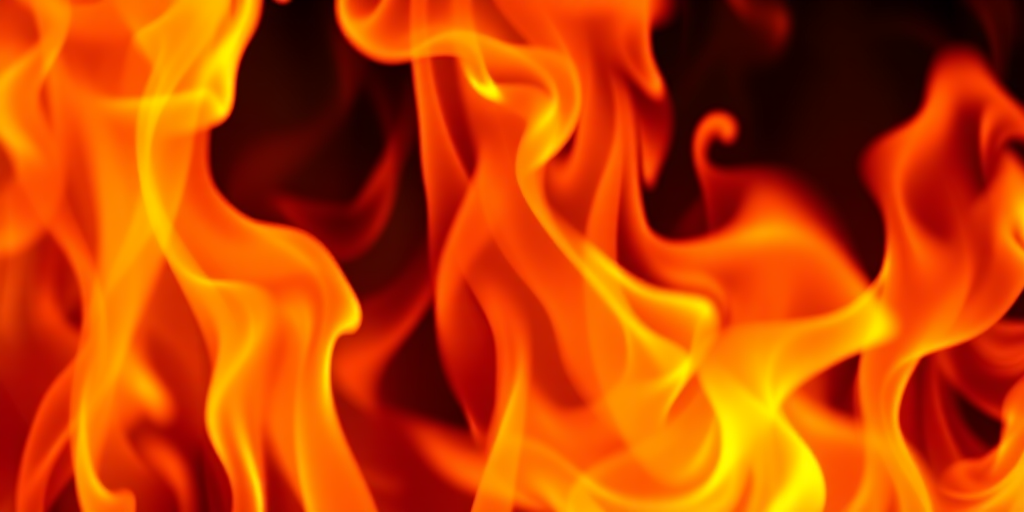 Create an abstract image of vibrant orange and yellow flames, focus on dynamic movement and texture, set in a medium close-up view, using a DSLR camera with a 50mm lens at f/8, ISO 100, and a shutter speed of 1/125s to enhance image quality and detail.