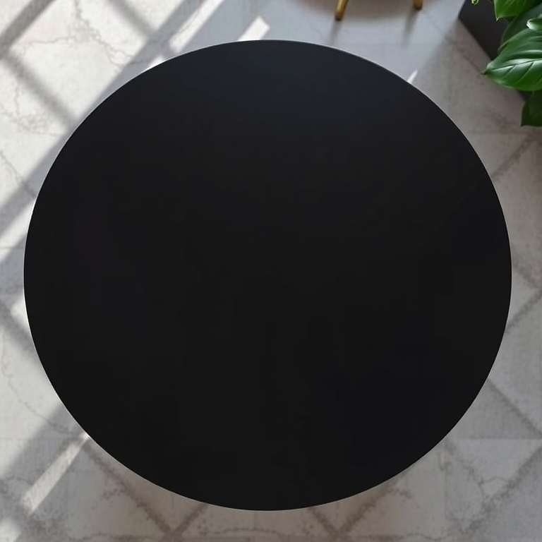 Create a high-resolution image of a modern black table viewed from above, using a DSLR camera with a 50mm lens, aperture set to f/2.8, ISO 100, with soft natural light to highlight the table's texture and shine.