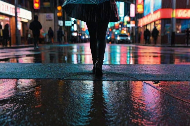 Rain-soaked city street, reflections of neon signs glowing in puddles, a woman standing at a crosswalk holding a clear umbrella, her silhouette framed by the vibrant lights.