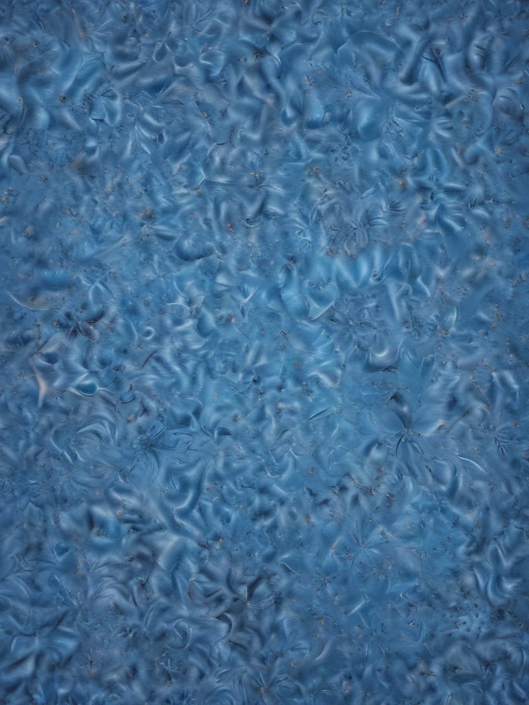 Textured Blue Surface with Swirling Patterns and Subtle Variations in Tone