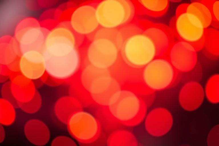 Create a vibrant abstract image of glowing orbs in shades of red and orange with a blurred bokeh effect, shot with a Canon EOS R5, 50mm lens, f/1.8 aperture, ISO 200, 1/60s shutter speed, and a soft focus background.
