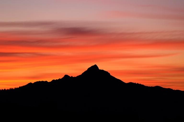 Generate a black silhouette of a mountain range against a gradient sunset background with rich colors, use a Canon EOS R5 camera, 24mm lens, aperture f/11, shutter speed 1/250 sec, ISO 100, landscape orientation.