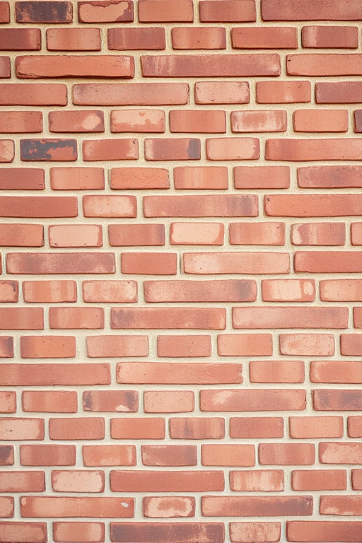 Regenerate an image of a textured red brick wall, capture in high resolution with a Canon EOS 5D Mark IV, using a 50mm lens, aperture set to f/8, ISO 100, and a soft, diffused natural light for even illumination.