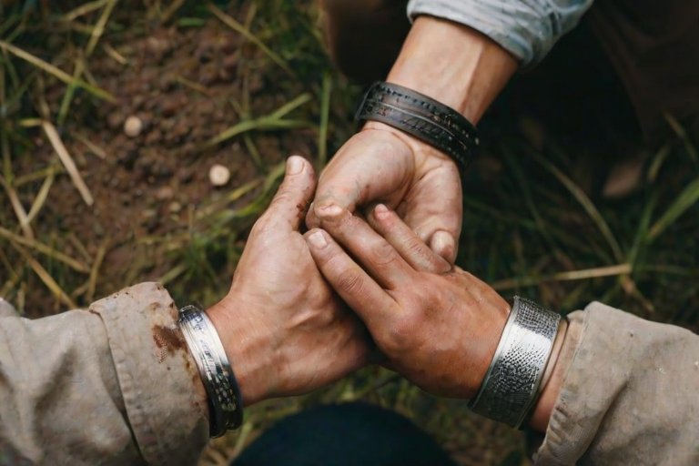 detailed edges, detailed image, perfection style, A cinematic detailed high angle from above image of a man with dirty hands and dirt on them, movie themed, sharp, detailed background, epic cinematic photography, artistic style, dramatic light style, cinematic color style, Kodak 35mm film style, detailed style, hand focus style, solo, shirt, 1boy, jewelry, male focus, outdoors, belt, pants, blurry, blurry background, ring, close-up, black belt, brown pants, multiple boys, 2boys, realistic, wedding ring, grass, yaoi, outstretched hand, hand focus