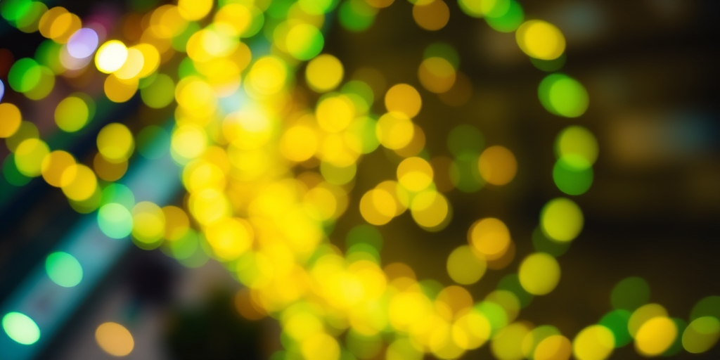 regenerate an abstract swirl of vibrant green and yellow bokeh lights with a zoom effect, using a DSLR camera at f/2.8 aperture, ISO 100, 1/60s shutter speed, from a bird's eye view in a wide-angle lens style for enhanced depth and clarity