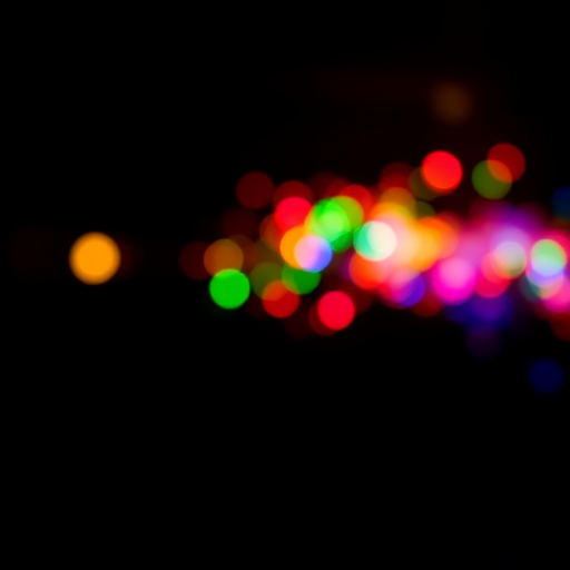 long exposure shot of colorful light trails on a black background, 24mm lens, f/4 aperture, ISO 100, shutter speed 2 seconds, taken with a DSLR camera, in a studio environment, using low light to emphasize vibrancy and motion blur.